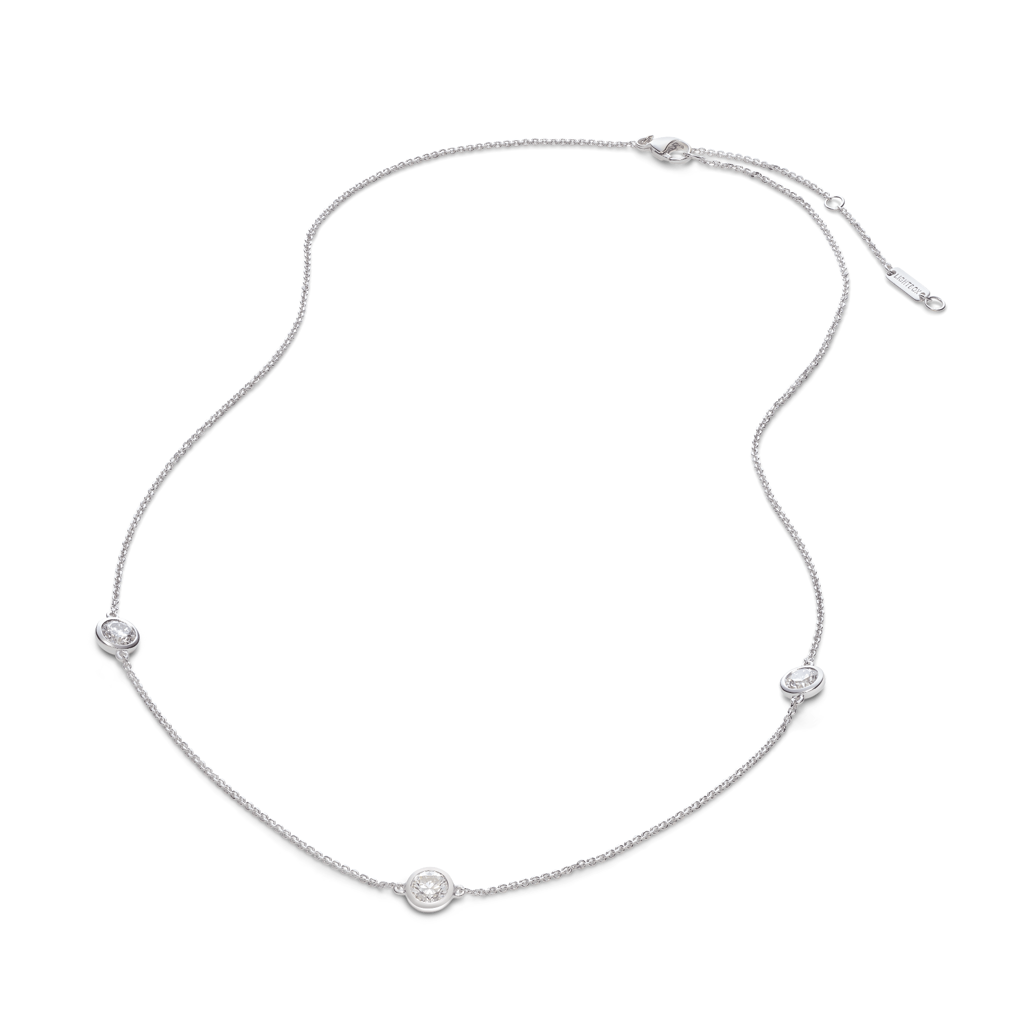 Overview of white gold 0.75 carat total weight bezel station pendant